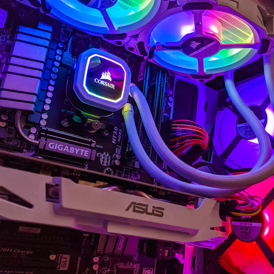 White gaming PC interior with RGB fans and liquid cooler