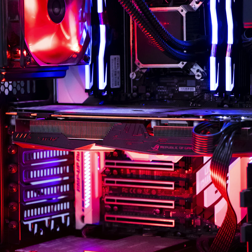 Gaming PC interior lit in red and blue with liquid cooling and RGB memory